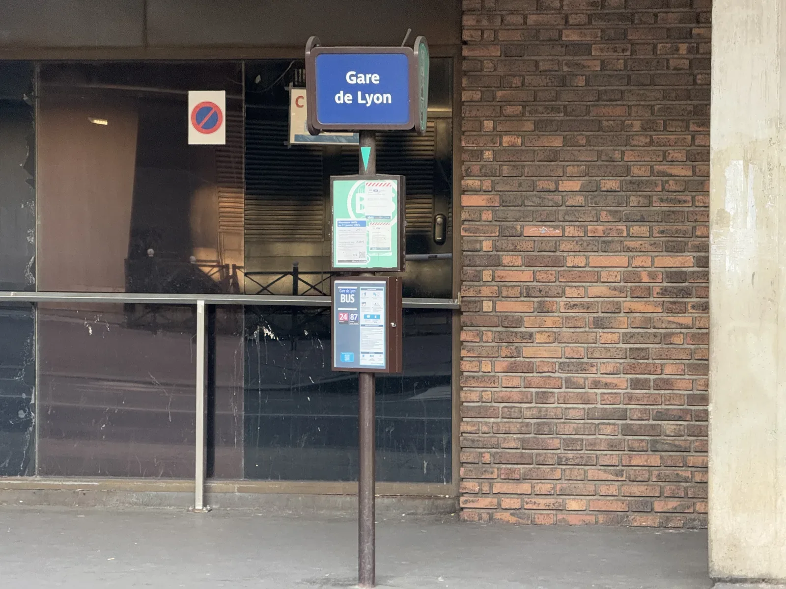 A Gare de Lyon bus-stop post with route-information panels on Rue de Bercy in Paris.