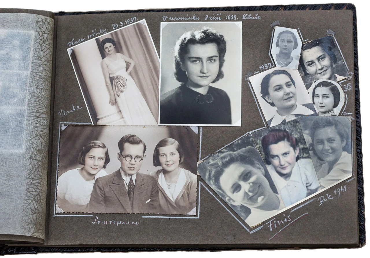 An open family album page with black-and-white portraits and handwritten dates.