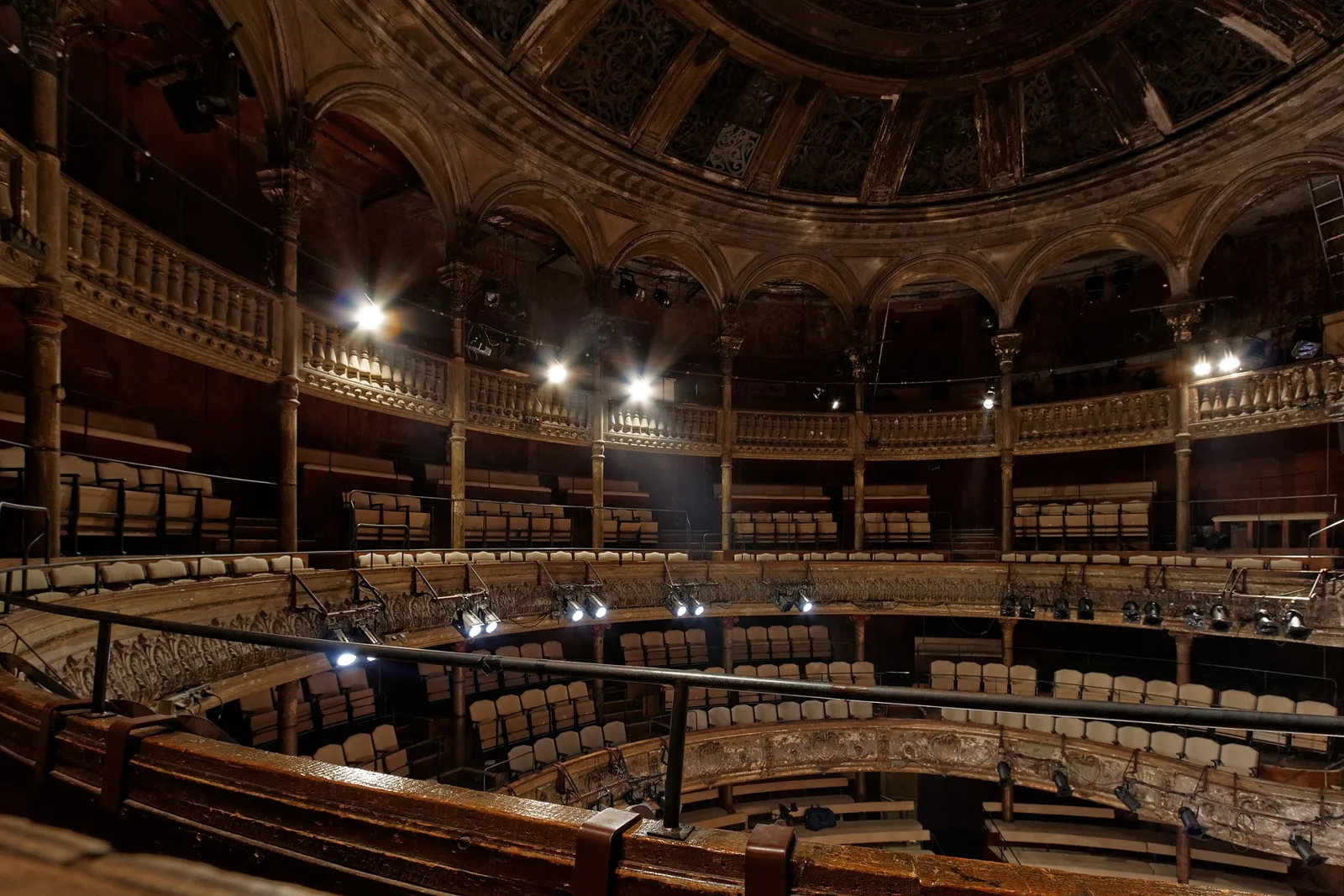 Empty seats and curved balconies inside the Théâtre des Bouffes du Nord.