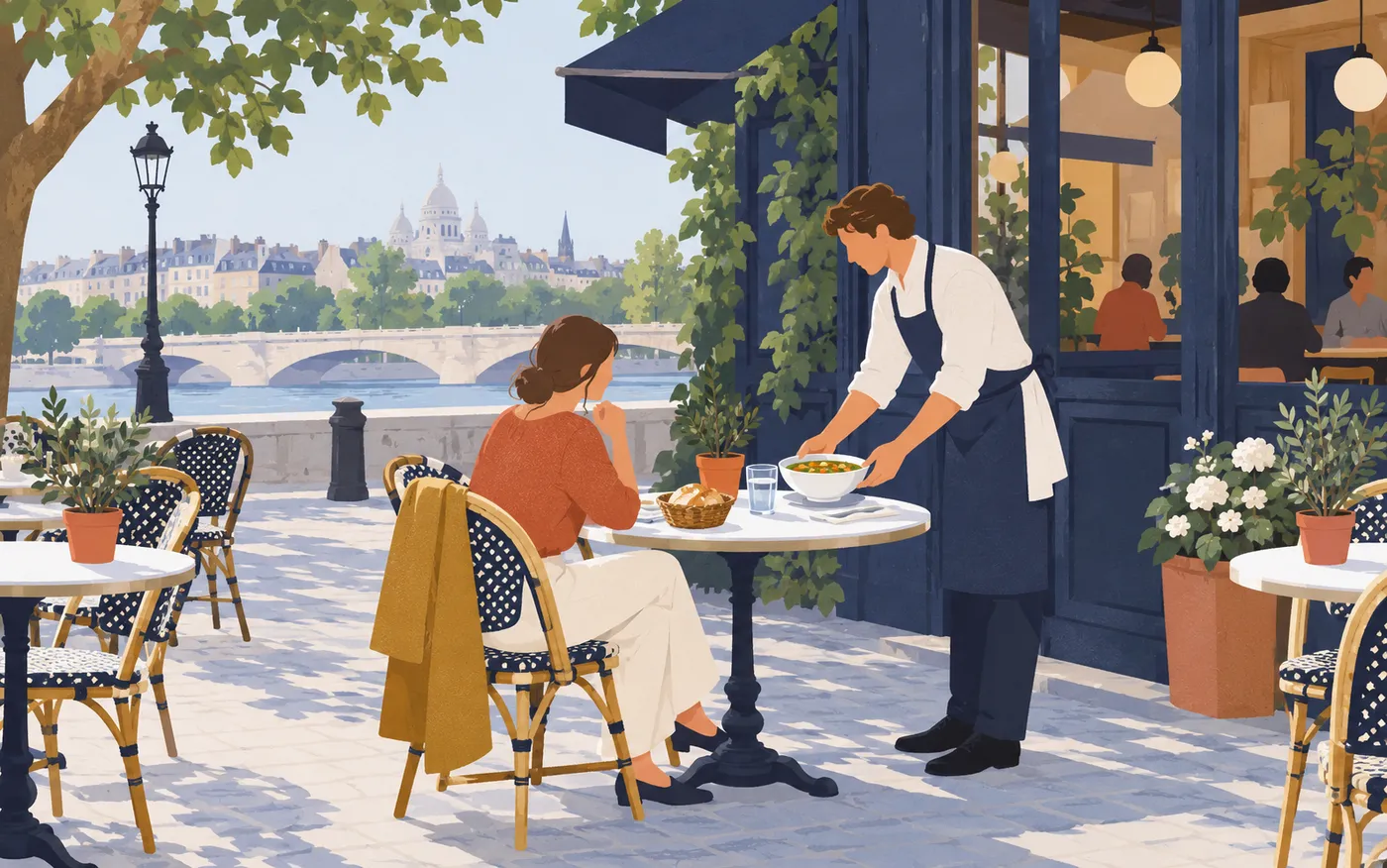 A server brings soup to a customer at a café table.