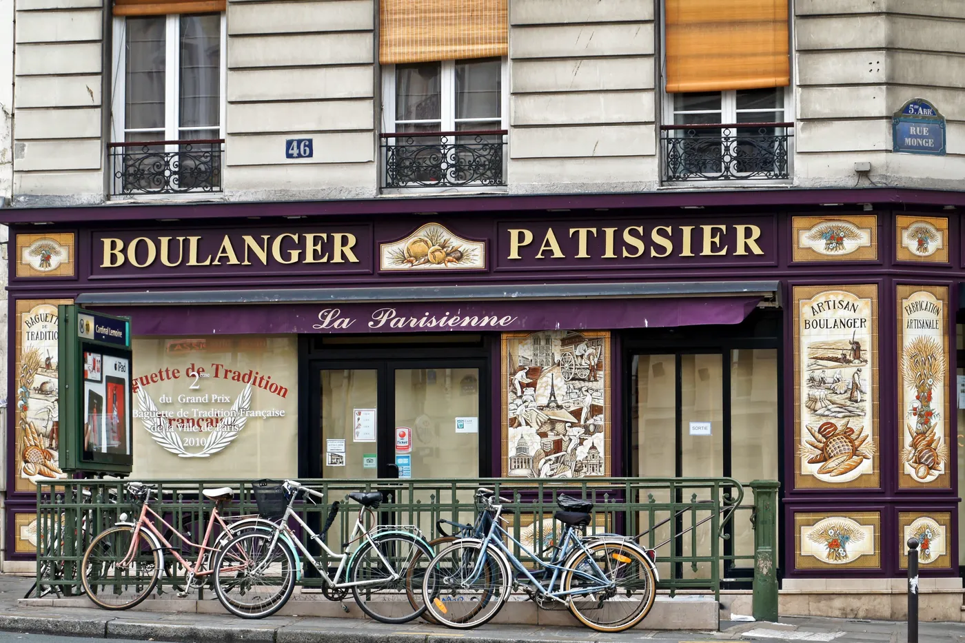 The decorated façade of a Paris boulangerie, with bicycles outside.